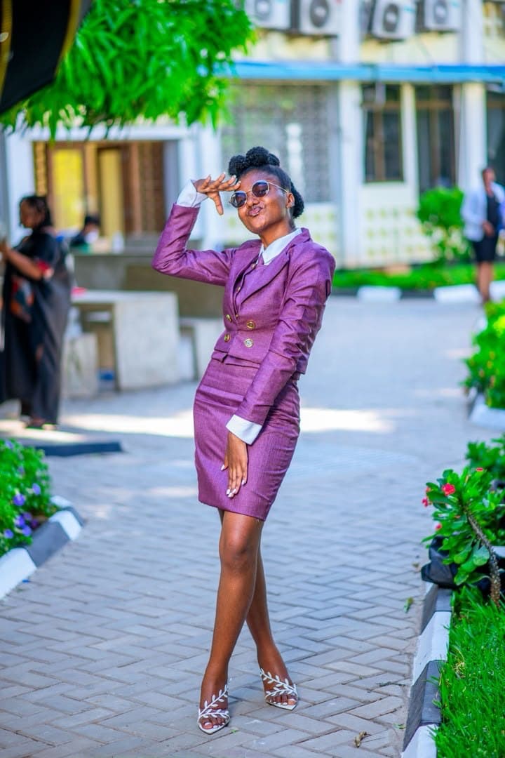 Purple suit, campus buildings behind